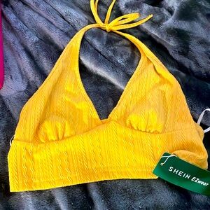 Yellow halter top
Ties at the neck 
Deep V neck